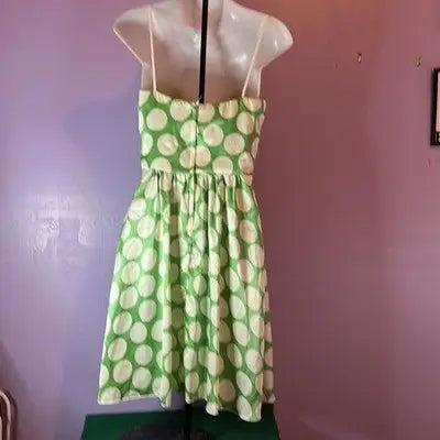 Green and white polka dot sundress on mannequin for IN San Francisco Dress Size 7