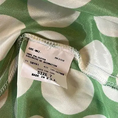 Green and white polka dot fabric with clothing tag from San Francisco dress size 7