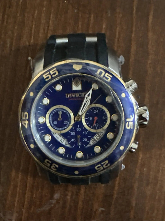 Invicta Pro Diver men’s wrist watch with blue dial, gold accents, and black rubber strap