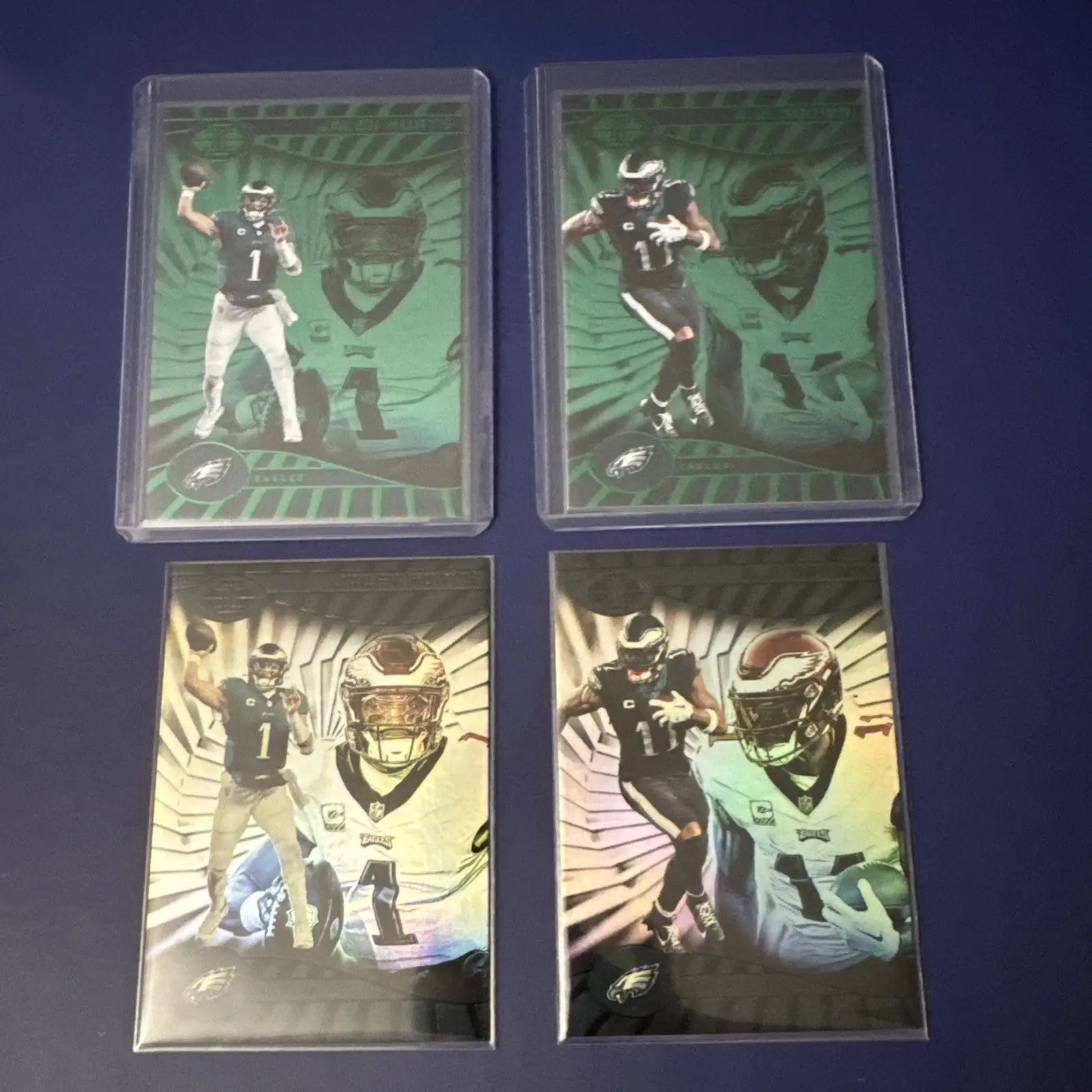 Philadelphia Eagles trading cards featuring Jalen Hurts in Panini Illusions Emerald and Base Color Match protective sleeves