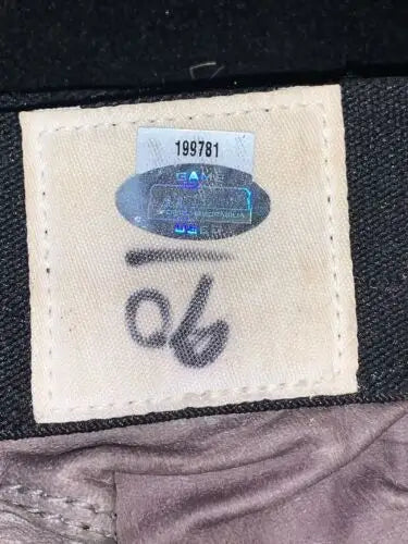 Fabric tag with authentication sticker and numbers for Jay Ratliff Dallas Cowboys gloves