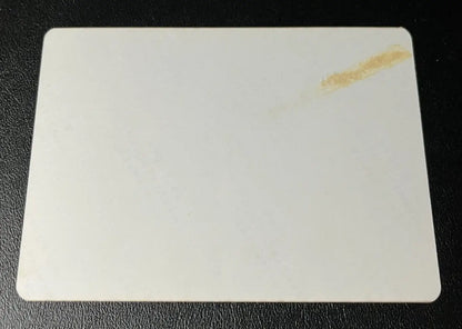 Rectangular white baseball card with rounded corners and a stain featuring Joe DiMaggio Yankees