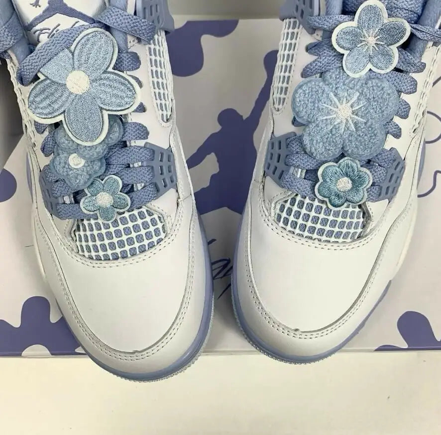 Jordan 4 Forget Me Not sneakers with blue flower embellishments, fast shipping available