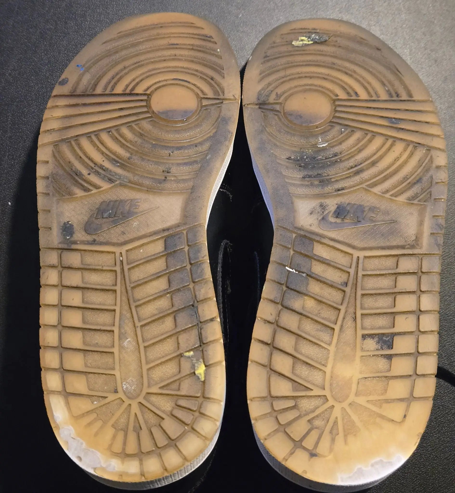 Worn light brown translucent rubber outsoles of Jordan Shoes Mens Black Patent High Top Air Jordan 1
