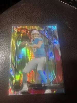 Justin Herbert 2024 Panini Select Red Yellow Shock Prizm football trading card with holographic design