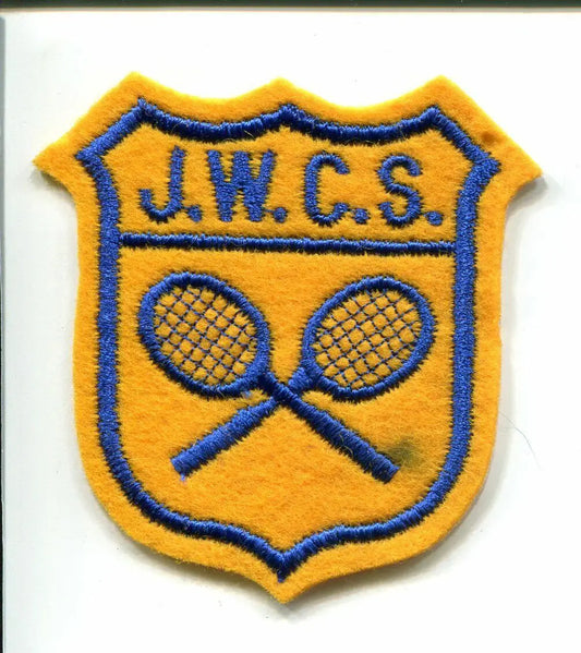 Gold and blue shield patch with tennis rackets from JWCS Junior Womens Tennis Maureen Connolly