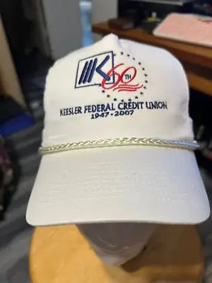 White baseball cap with braided rope accent from Keesler Federal Credit Union