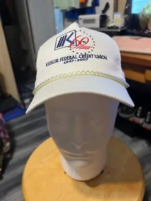 White baseball cap with braided gold trim from Keesler Federal Credit Union 2007 Cobra SnapBack