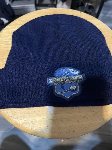 Navy blue knit beanie with Kennedy Memorial Hockey Tournament patch, perfect for hockey tournament fans