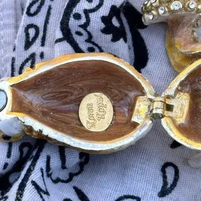Open Keren Kopal crystal apple trinket box with gold rim and small circular label