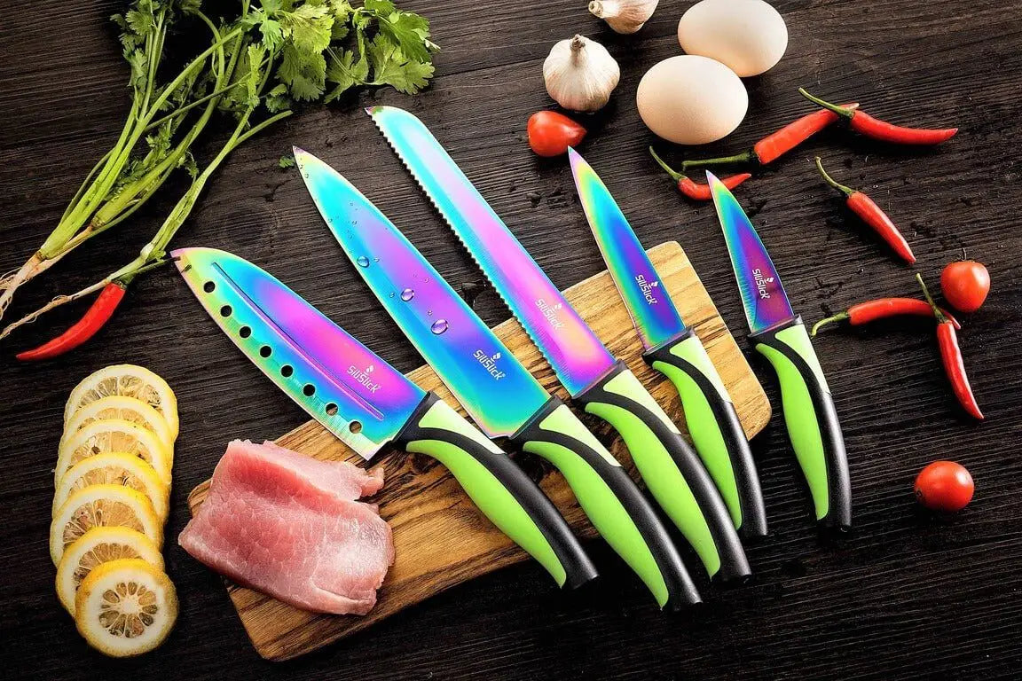 Iridescent kitchen knife set with green and black handles on red magnetic rack