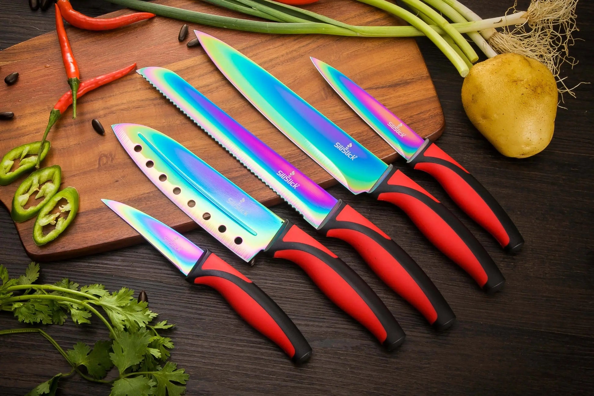 Iridescent kitchen knife set with red and black handles on red magnetic rack and sharpener