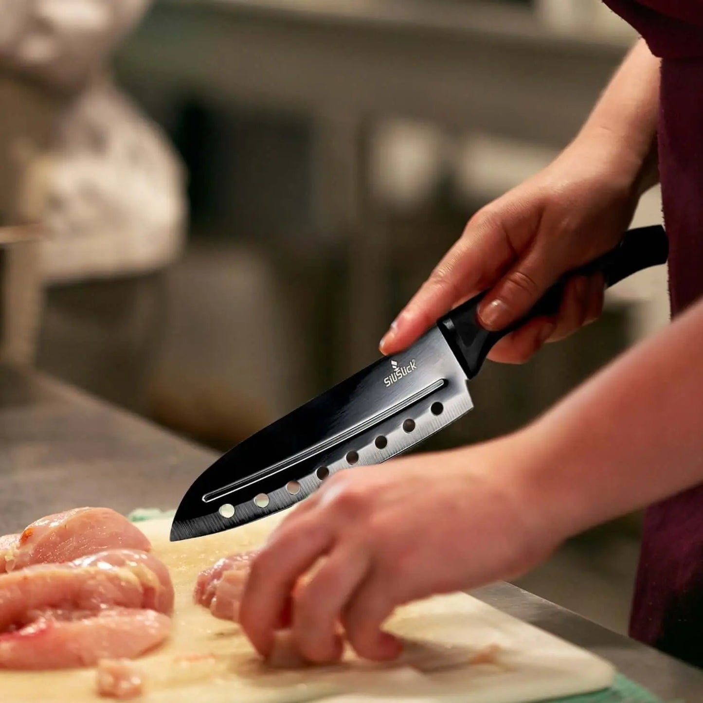 Black chef’s knife with perforated blade and ergonomic handle from Kitchen Knife Set Kit