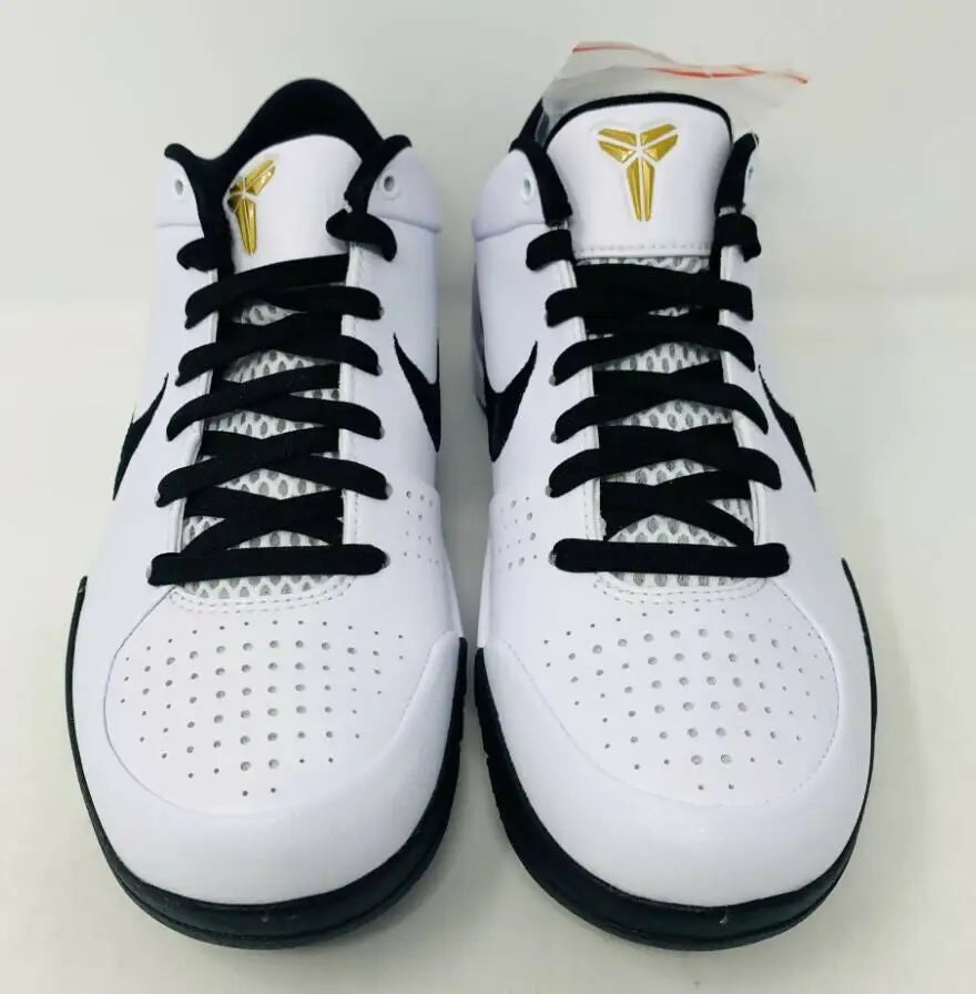 White and black Nike Kobe basketball shoes with gold logos, fast shipping available