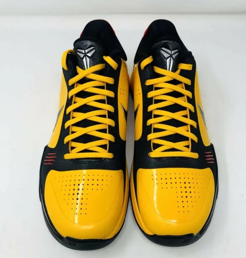 Black and yellow Kobe 5 Bruce Lee athletic shoes with silver Kobe logos and yellow laces