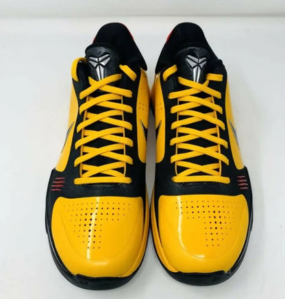 Black and yellow Kobe 5 Bruce Lee athletic shoes with silver Kobe logos and yellow laces