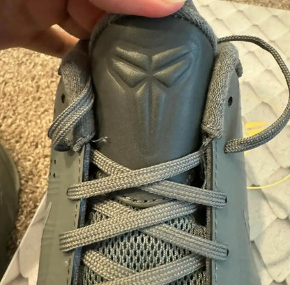 Close-up of Grey Kobe 5 Fade To Black athletic shoe with textured tongue and logo
