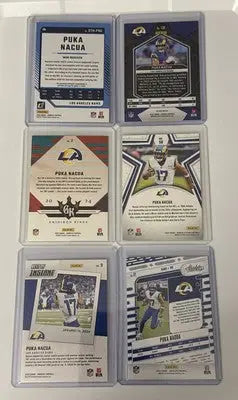 Puka Nacua football trading cards in protective cases from LA Rams lot including Prizm and Threads