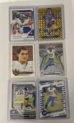 Six Puka Nacua football trading cards in clear protective sleeves for LA Rams collectors
