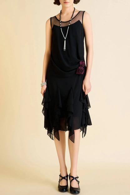 Black flapper-style dress with sheer neckline, tiered ruffled skirt, and floral embellishments