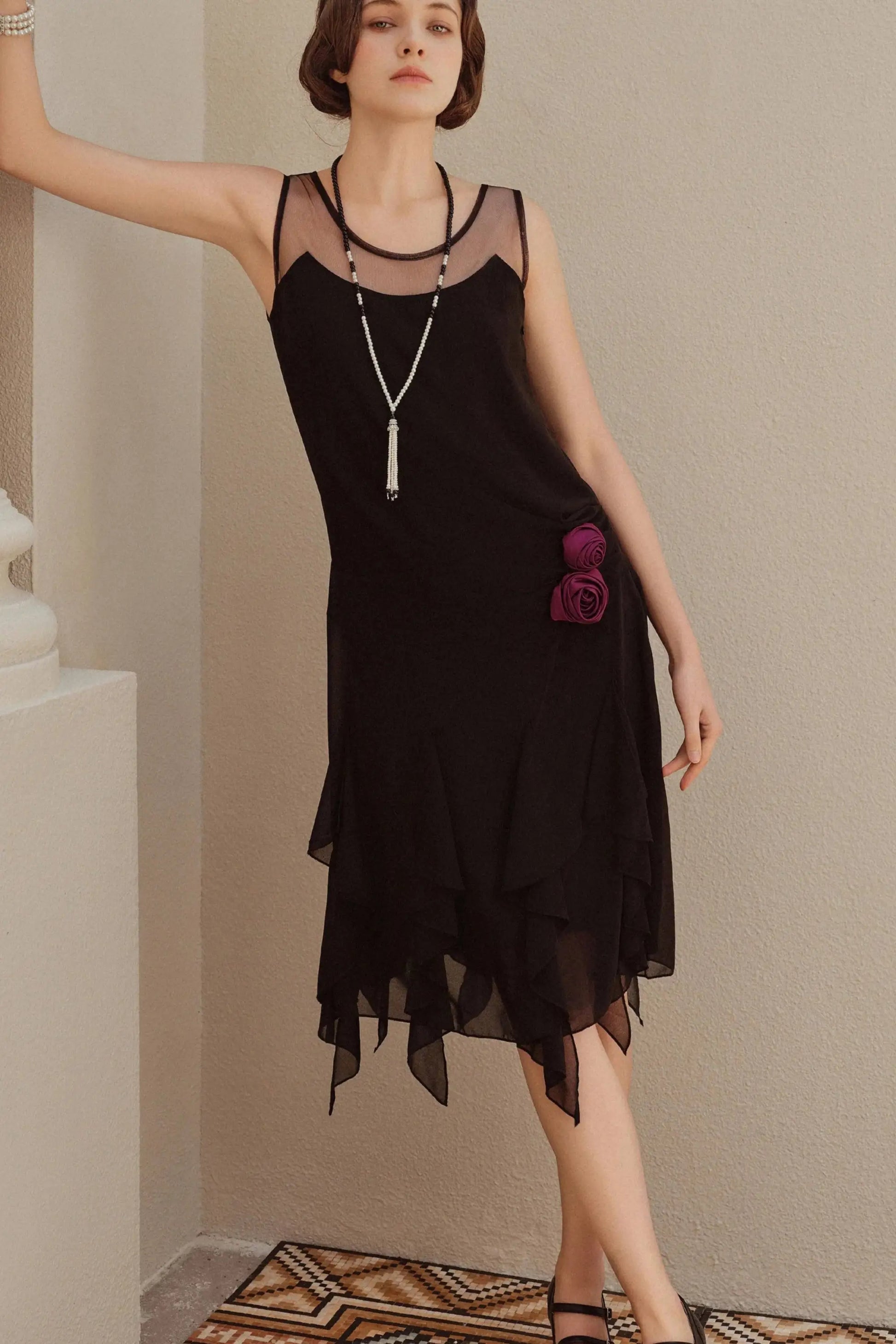 Black sleeveless flapper dress with sheer décolletage and purple floral appliqués