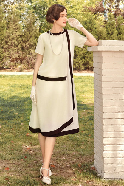 Cream-colored Downton Abbey replica dress with draped cascading ruffle and pearl necklace