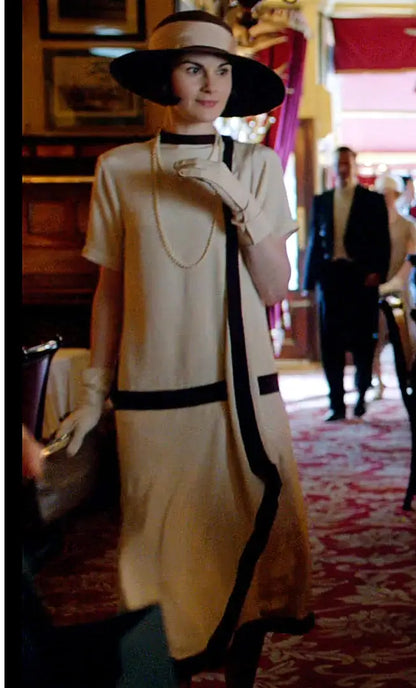 Woman modeling a Downton Abbey replica cream-colored draped cascading Gatsby dress