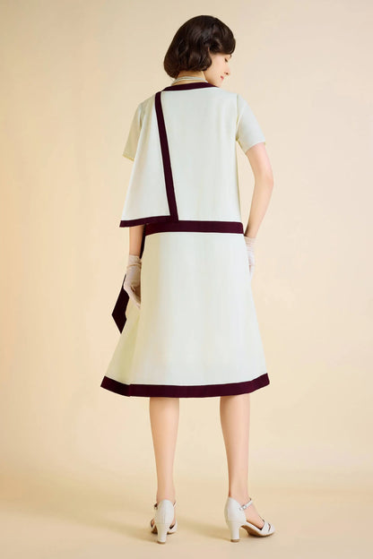 Women’s pale green Downton Abbey replica dress with dark red trim and draped cascading ruffles