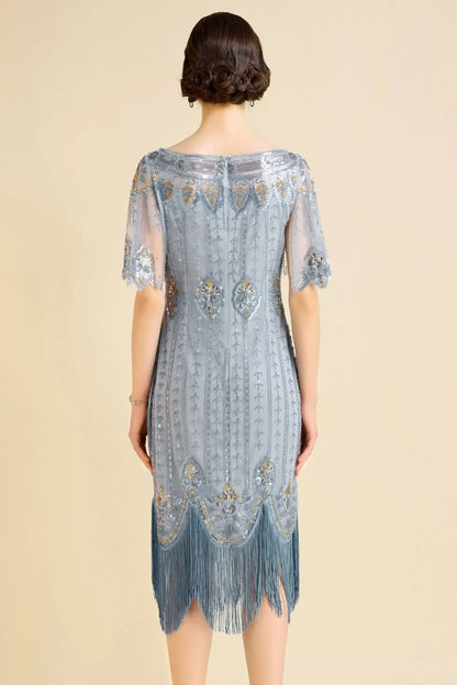 Woman modeling sky blue beaded flapper dress with fringe and boat neck for cocktail event