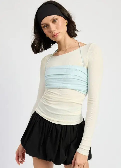 Long sleeve off-white sheer top with ruched light blue bandeau overlay and black mini skirt
