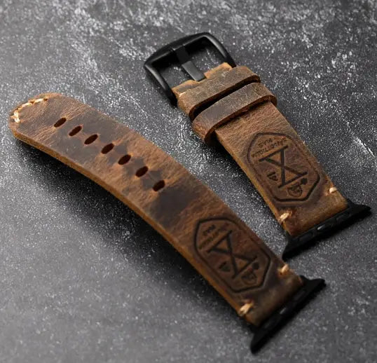 Distressed brown leather Apple Watch Ultra band with black buckles and contrasting stitching