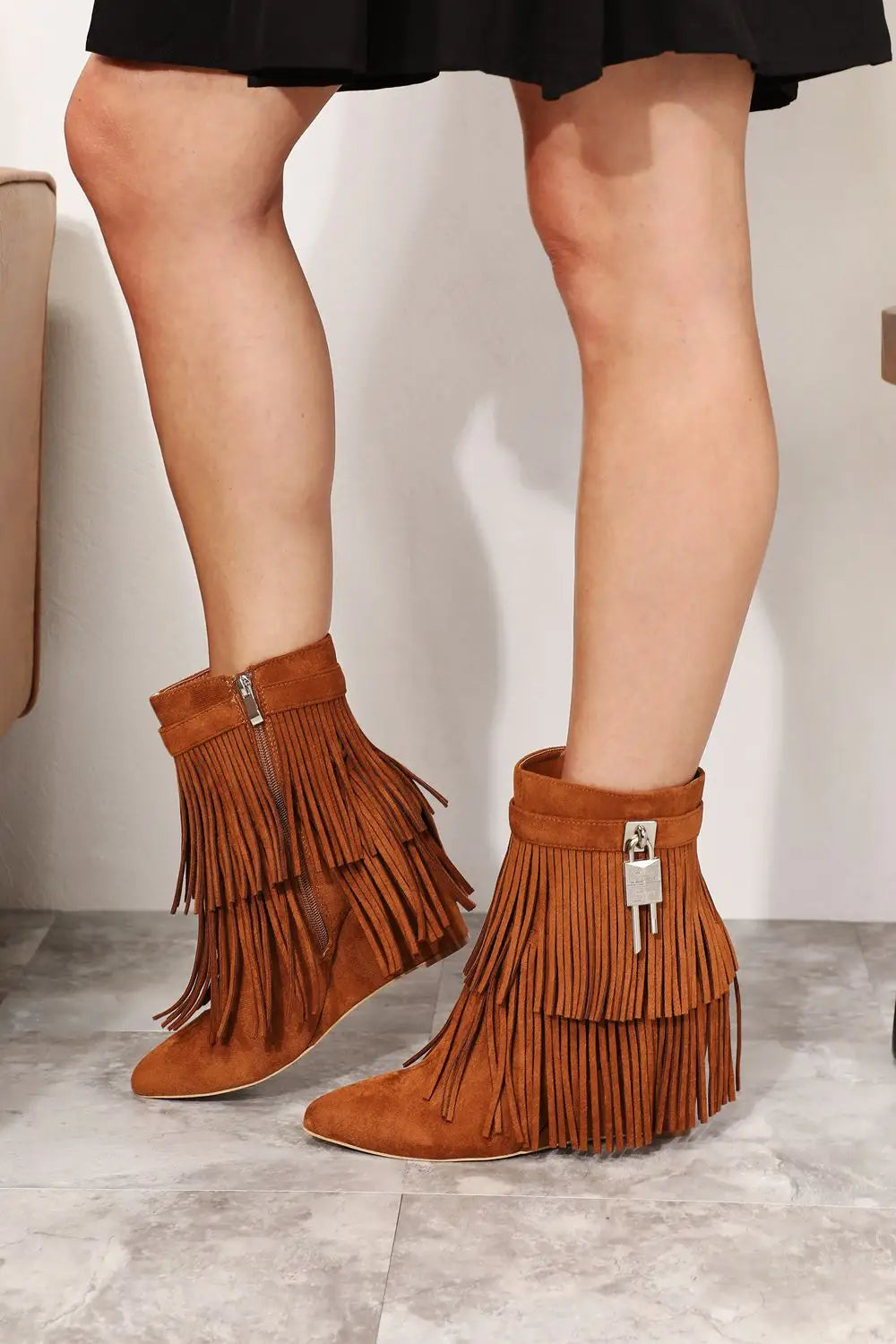 Tan suede Legend Womens Tassel ankle booties with fringe, wedge heel, and silver hardware
