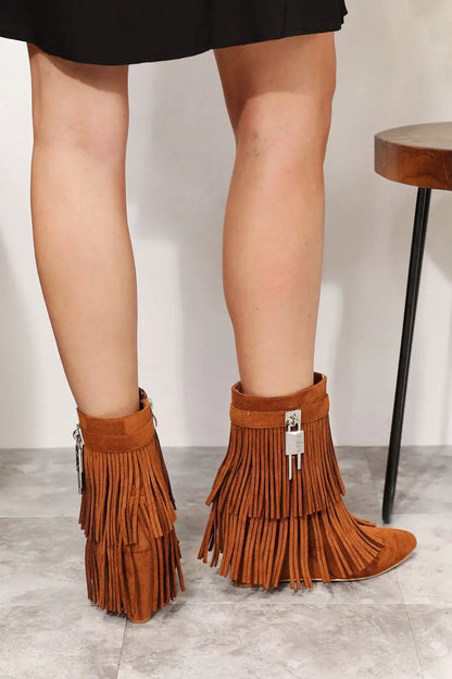 Tan suede ankle booties with fringe, zipper detail, silver hardware, and wedge heel