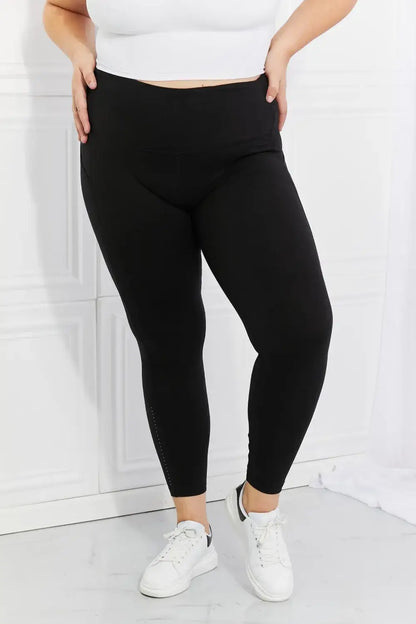 Plus-size black high-waisted active leggings with reflective dot details from Leggings Depot