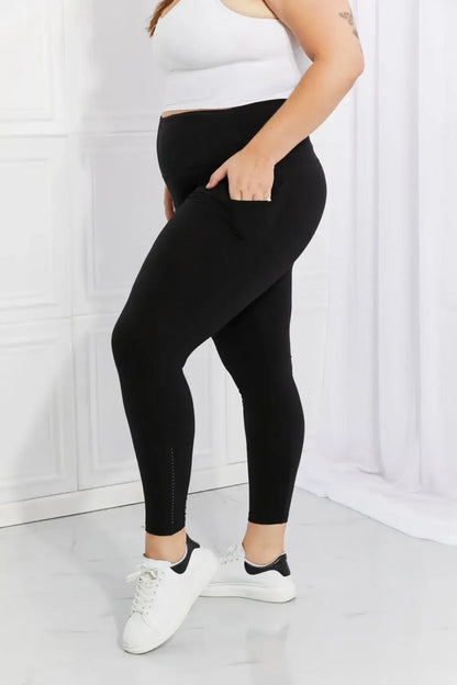 Plus-size woman wearing black active leggings with reflective dots from Leggings Depot