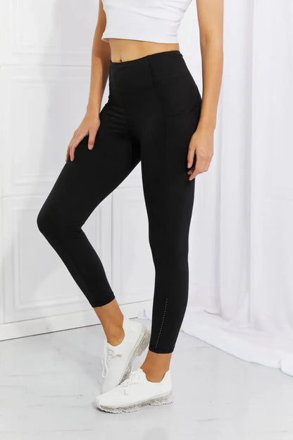 Black women’s capri-length active leggings with small studs and reflective dots at Leggings Depot