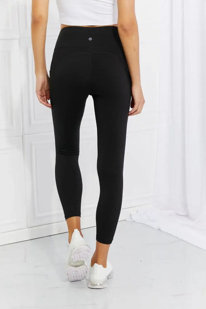 Black athletic leggings with high waistband and reflective dot detail from Leggings Depot