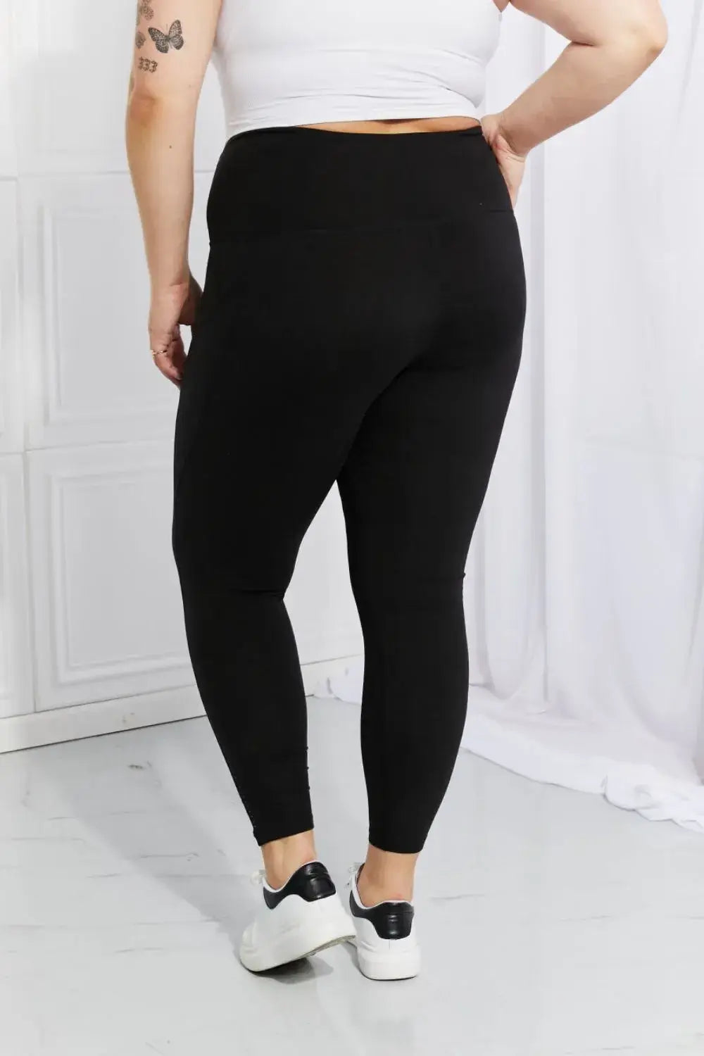 Plus-size black active leggings with reflective dot details and white sneakers from Leggings Depot