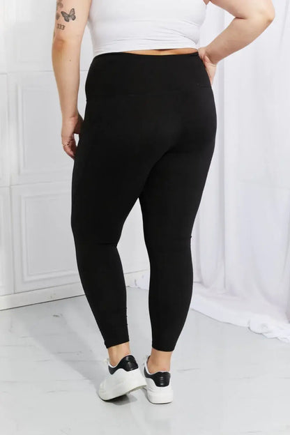 Plus-size black active leggings with reflective dot details and white sneakers from Leggings Depot
