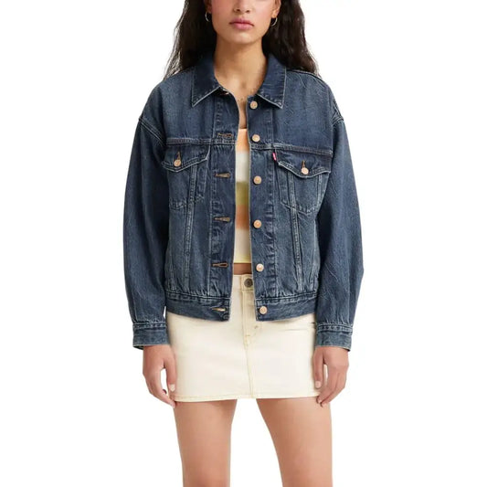 Woman wearing a blue denim trucker jacket from Levis Womens 90s Trucker Jacket collection