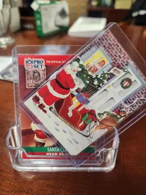 Trading card in protective case from Lot of 2 1990 & 1991 NFL Football Pro Set featuring Santa Claus Head Coach