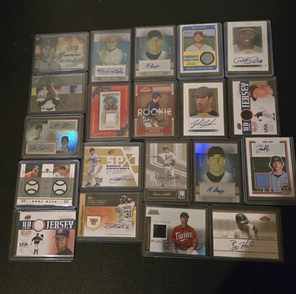 Collection of baseball trading cards with autographs and memorabilia including Aaron Nola and Kyle Waldrop