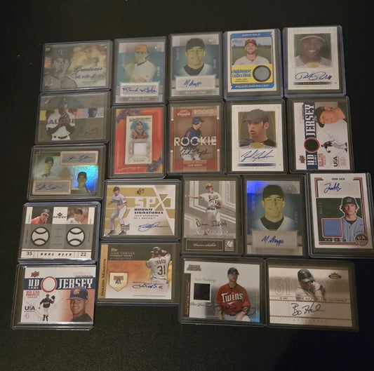 Collection of baseball trading cards with autographs and memorabilia including Aaron Nola and Kyle Waldrop
