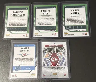 Collection of five Kansas City Chiefs NFL trading cards in protective cases featuring Mahomes and Kelce