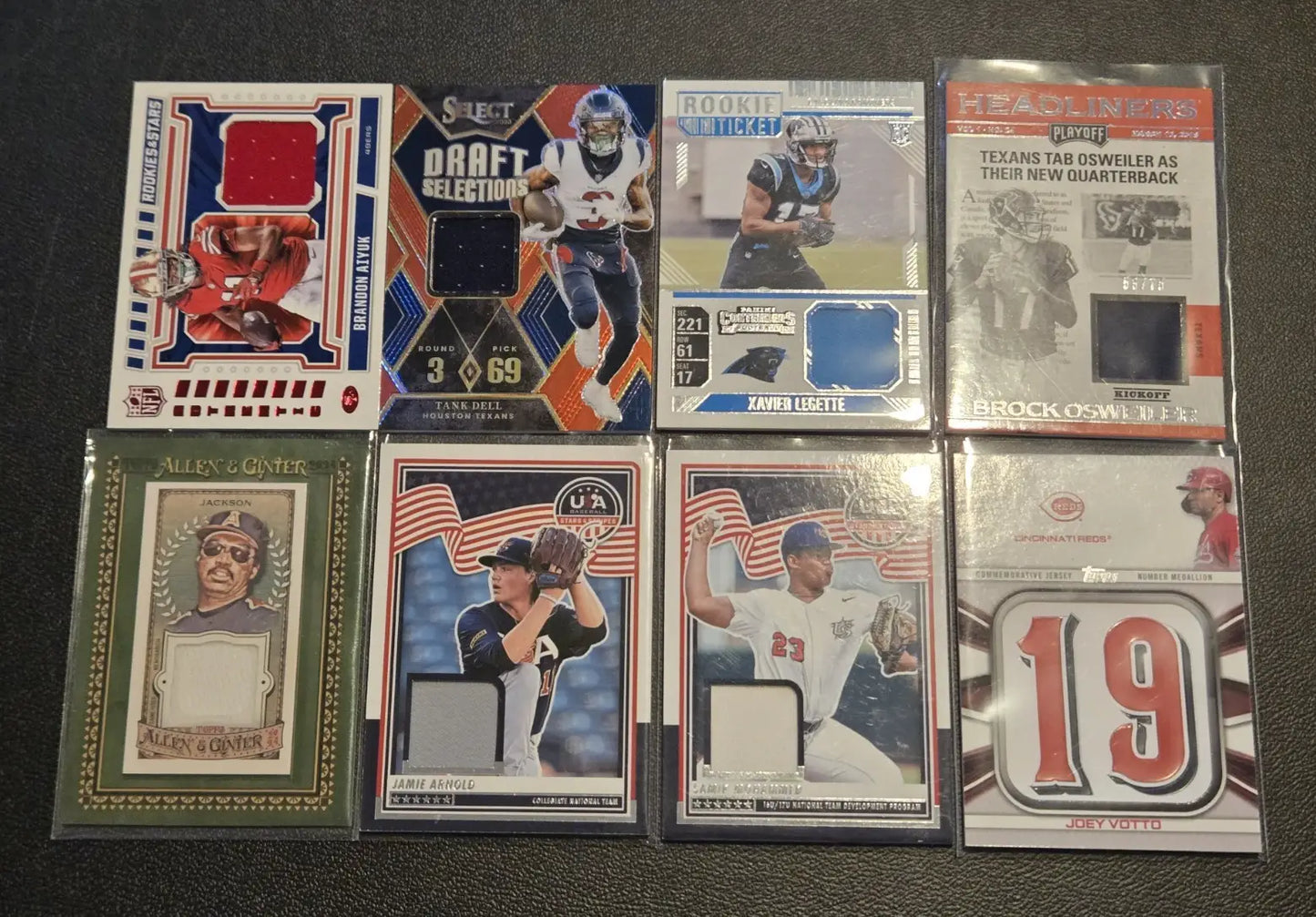 Collection of NFL MLB sports trading cards with jersey relic patches and memorabilia