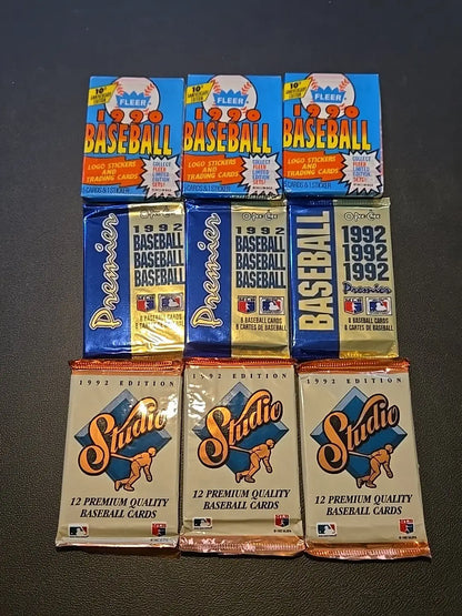 Lot of 9 vintage baseball card packs from the 1990s featuring Fleer and Premier