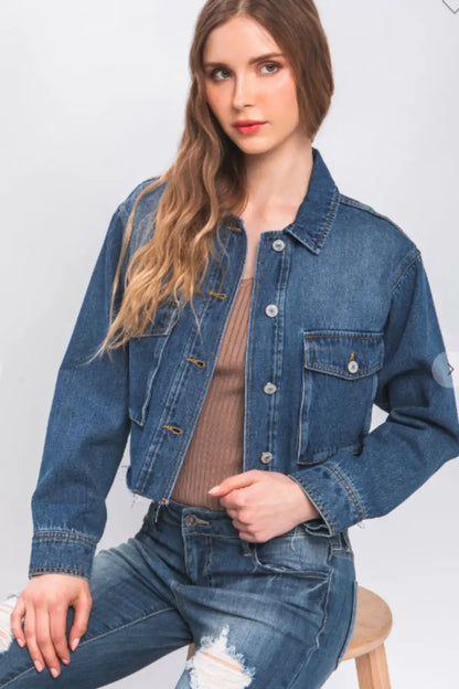 Denim jacket with raw hem distressed details and button closure in dark blue
