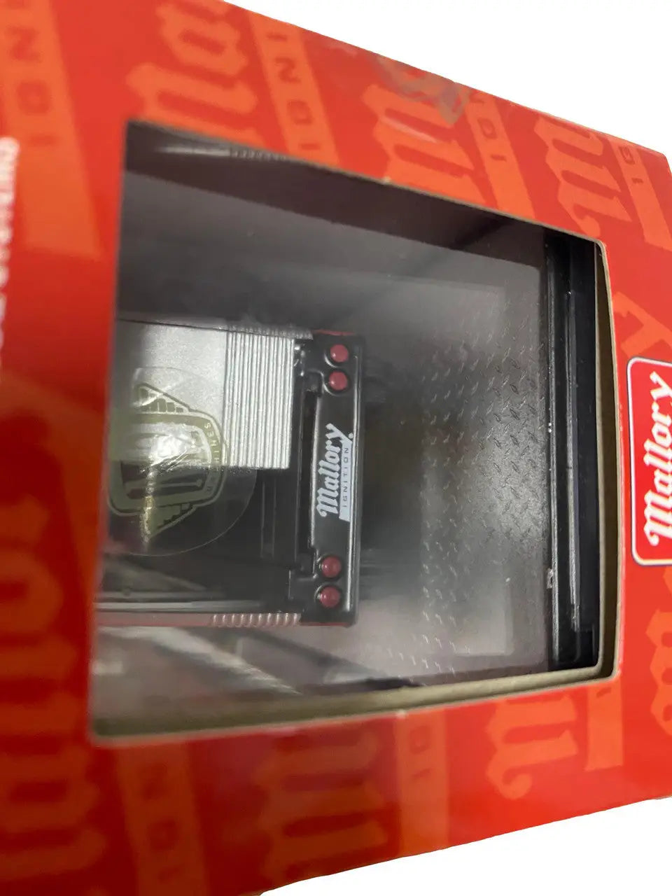 Black electronic device with red accents in clear packaging for M2 Machines Auto Hauler