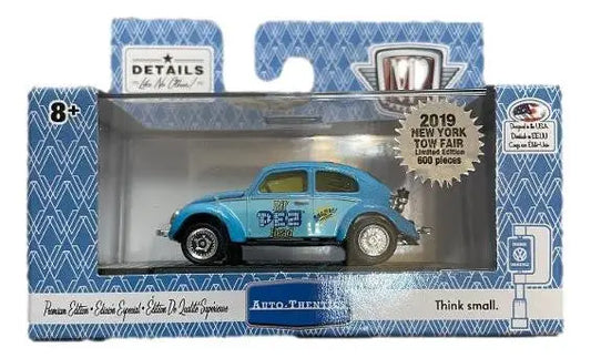 Die-cast light blue Volkswagen Beetle model with PEZ branding from York Toy Fair packaging