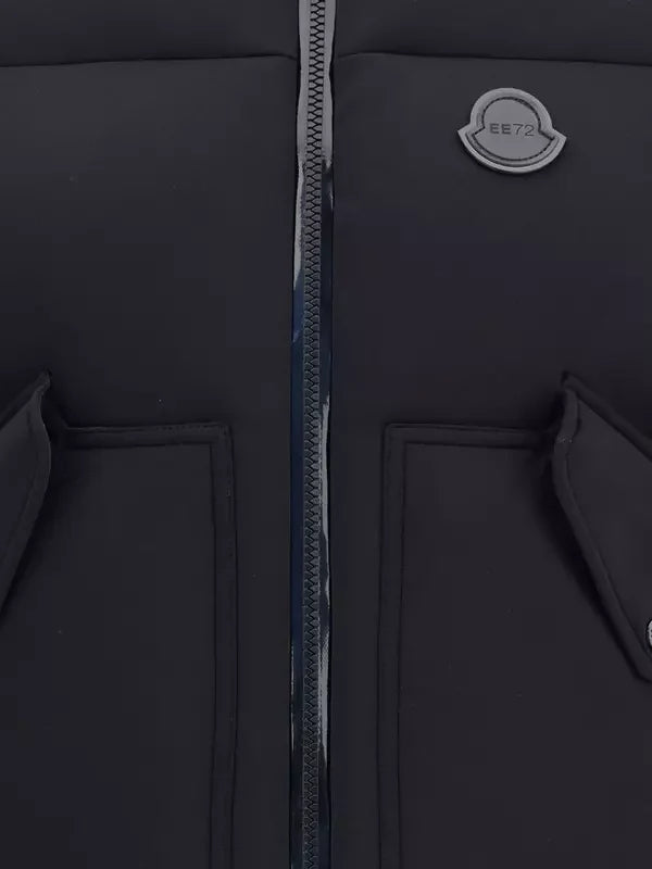 Close-up of a black jacket with a zipper and brand logo on a dark background